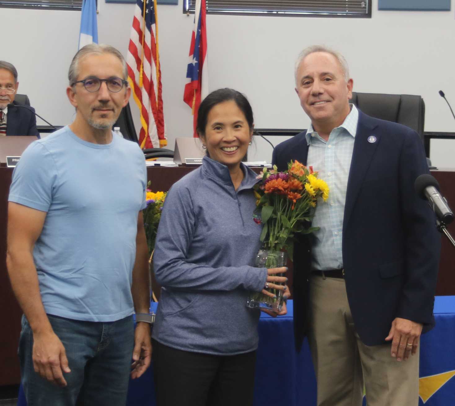 Mr. and Mrs. Wallace with flowers and Mayor Sirkin